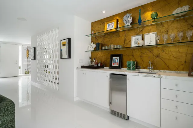 a view of patio with a table and chairs under an umbrella