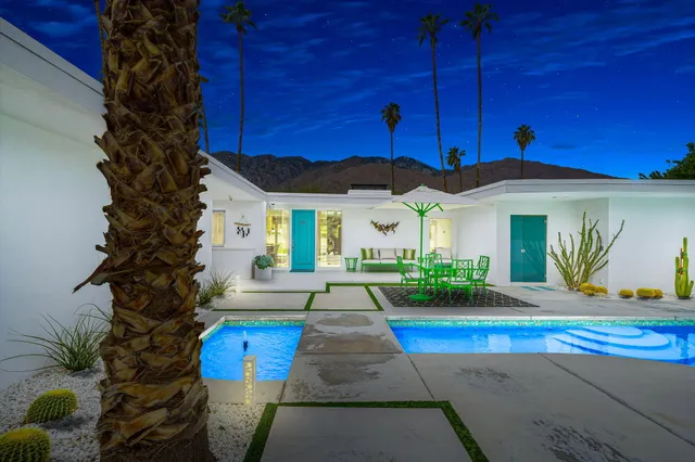 a view of a house with backyard sitting area and garden