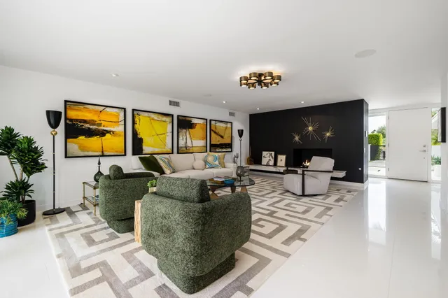 a view of a chairs and table in a back yard