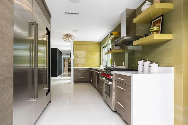 a front view of a house with garden and trees