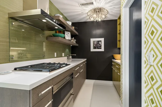 a front view of a house with garden and tree