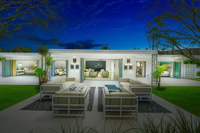 a view of a swimming pool with outdoor seating