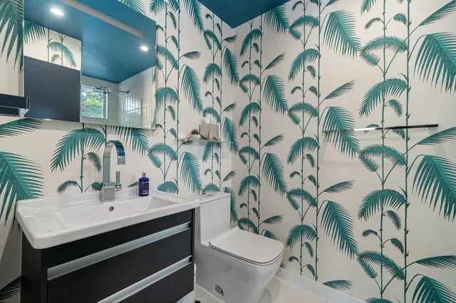 a view of a patio with table and chairs and a large tree