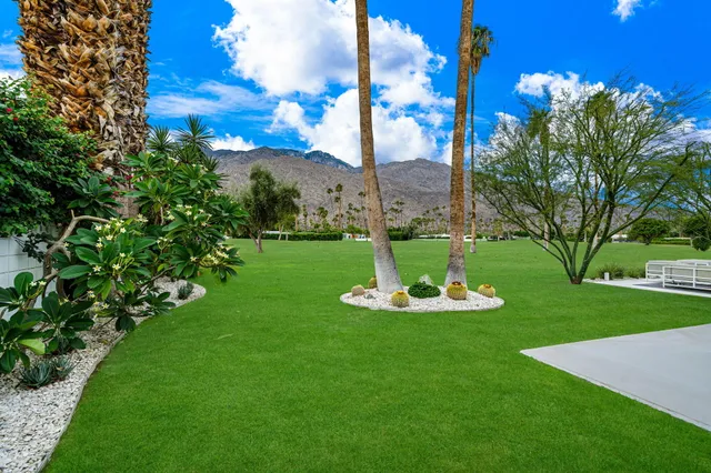a house view with a seating space and garden