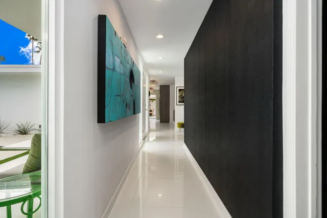 a view of a patio with table and chairs and a barbeque