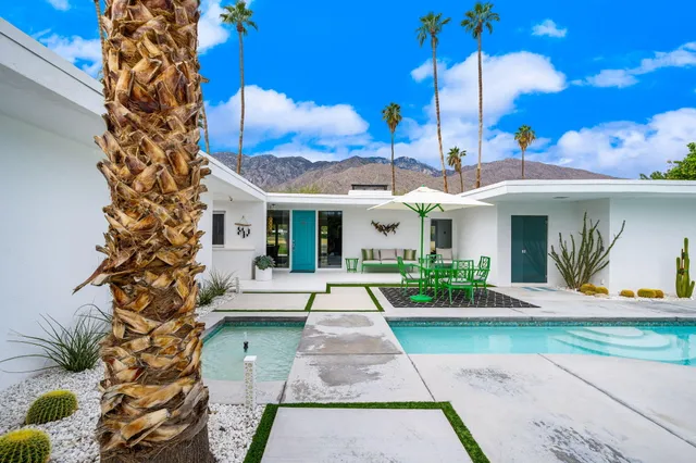 a front view of a house with a yard table and chairs
