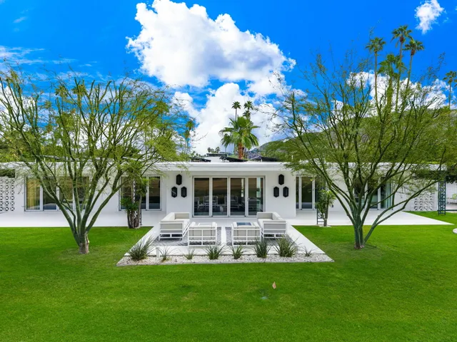 a view of a patio with a table and chairs