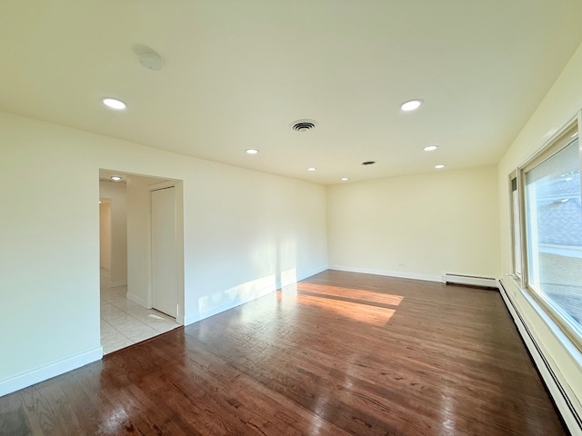 833 Heritage Drive, Unit 1 Addison, IL 60101 - Photo 10 of 14 an empty room with wooden floor and windows