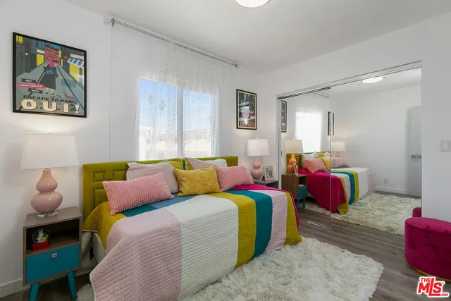 a bedroom with a bed and window