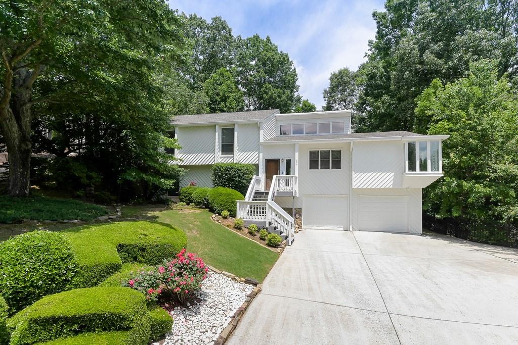 Curb appeal galore in this modern contemporary home located in a fab swim and tennis community in popular Roswell.