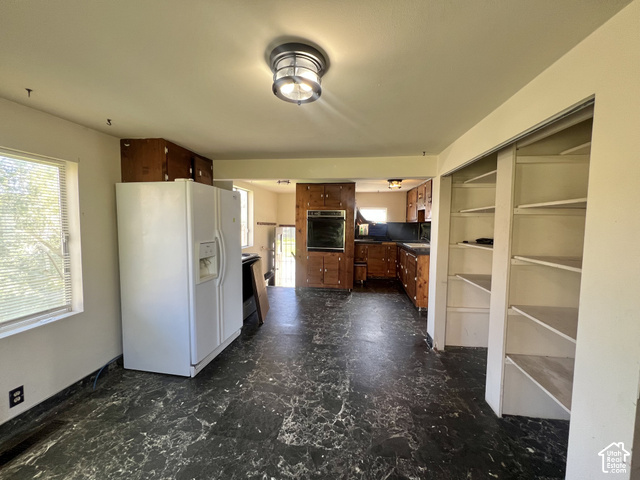 265 Roosevelt Street Helper, UT 84526 - Photo 12 of 27 Kitchen area featuring wood cabinetry, built-in oven, and a pantry with shelving