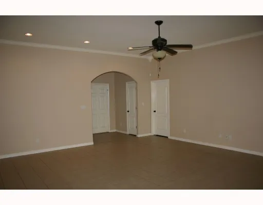 a view of empty room with ceiling fan