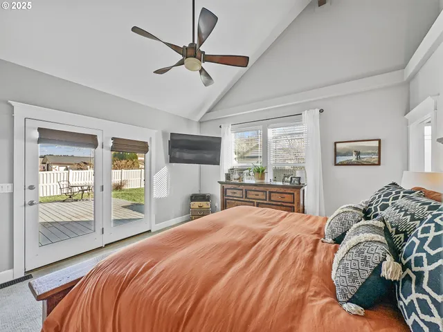 a bedroom with a bed and a large window