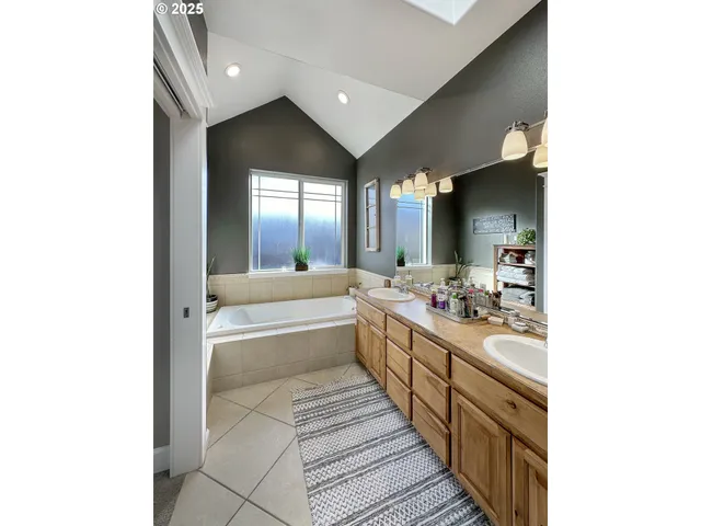 a large en suite bathroom with sink and mirror