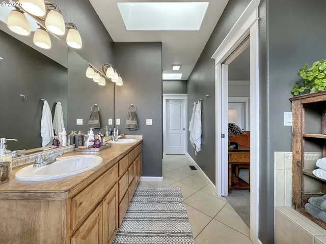 a bathroom with a double vanity sink and a mirror