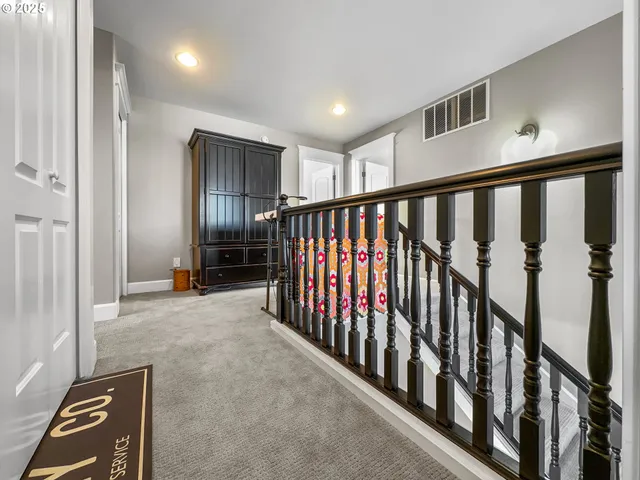 a spacious bathroom with a granite countertop sink a toilet and a mirror