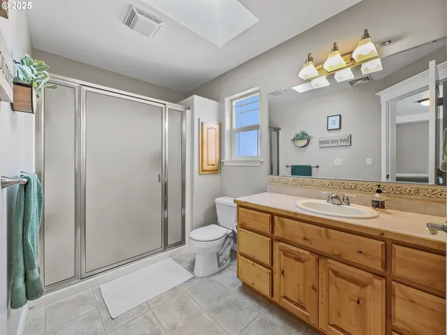 a spacious bedroom with a bed and a large window