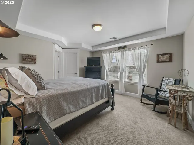 a living room with furniture and a book shelf