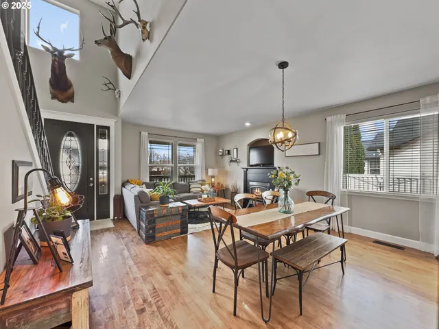 a dining room with furniture a chandelier and wooden floor