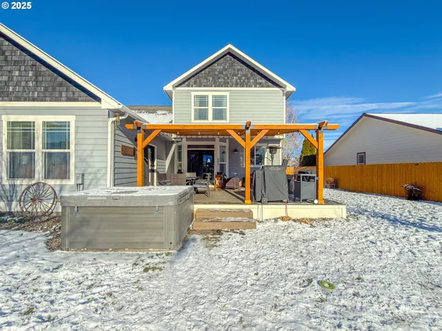 a view of a patio with table and chairs a barbeque with wooden floor and fence
