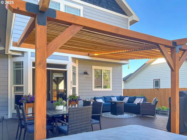 a view of a house with a yard and wooden fence