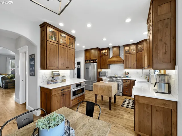 a living room with stainless steel appliances kitchen island granite countertop furniture and a kitchen view