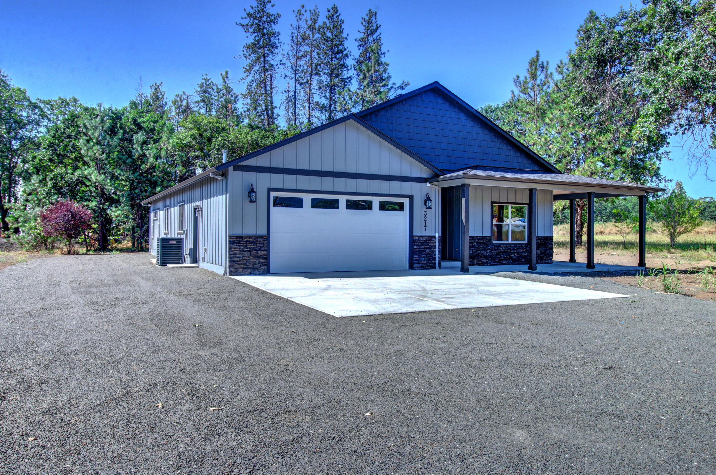 3217 Sams Valley Road White City, OR 97503 - Photo 2 of 40 a front view of a house with a yard and garage