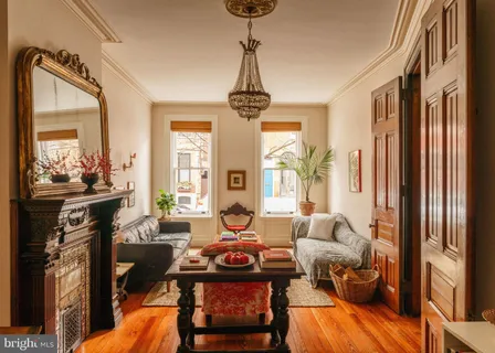 a living room with furniture a window and a chandelier