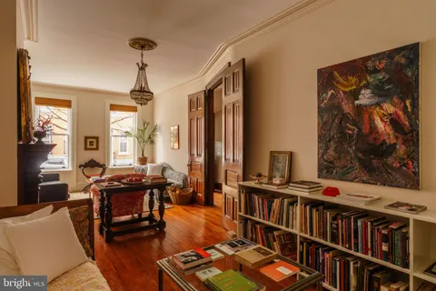 a dining room with furniture a chandelier and window