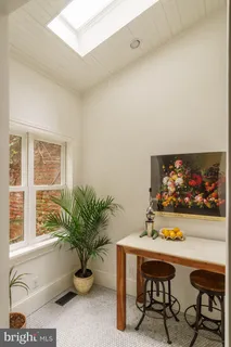 a view of a patio with table and chairs and wooden floor