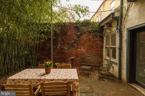 a living room with furniture a flat screen tv and a floor to ceiling window