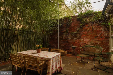 a living room with furniture a chandelier and a flat screen tv