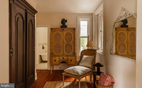 a bedroom with a bed and a large window with outer view