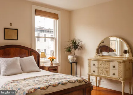 a bedroom with furniture and a window