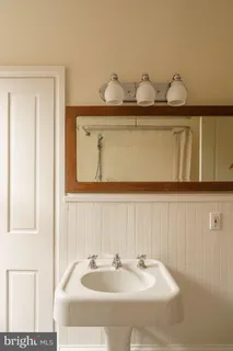 a living room with furniture a flat screen tv and a window