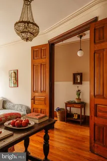 a living room with furniture a fireplace and a table