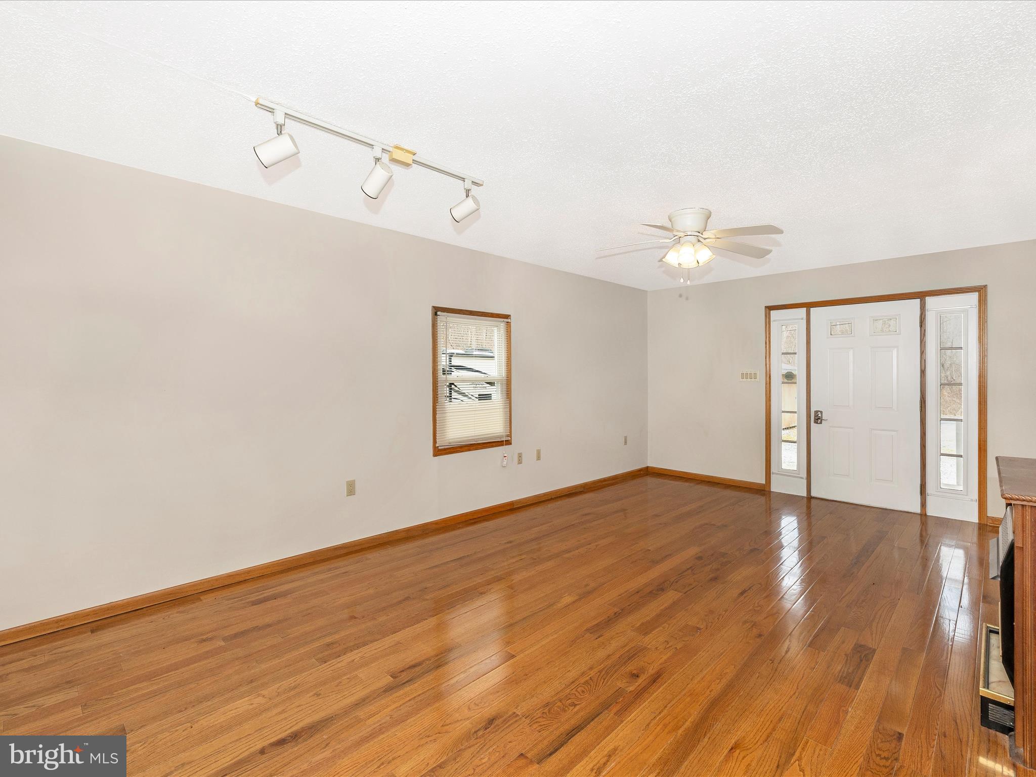 4439 John Draper Road Smithsburg, MD 21783 - Photo 10 of 63 a view of an empty room with wooden floor and a window