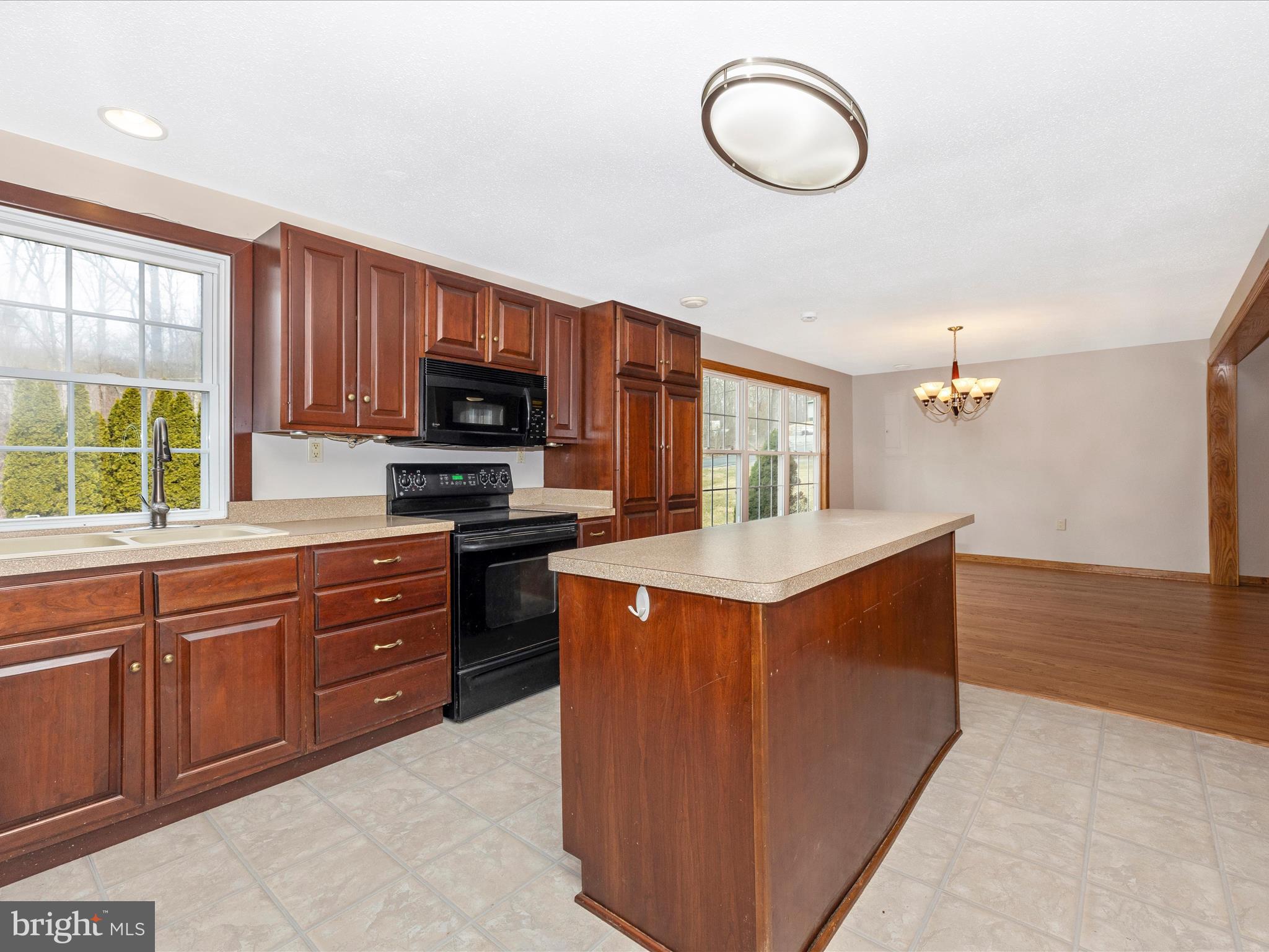 4439 John Draper Road Smithsburg, MD 21783 - Photo 14 of 63 a kitchen with stainless steel appliances granite countertop a stove a sink dishwasher and a microwave oven with white cabinets
