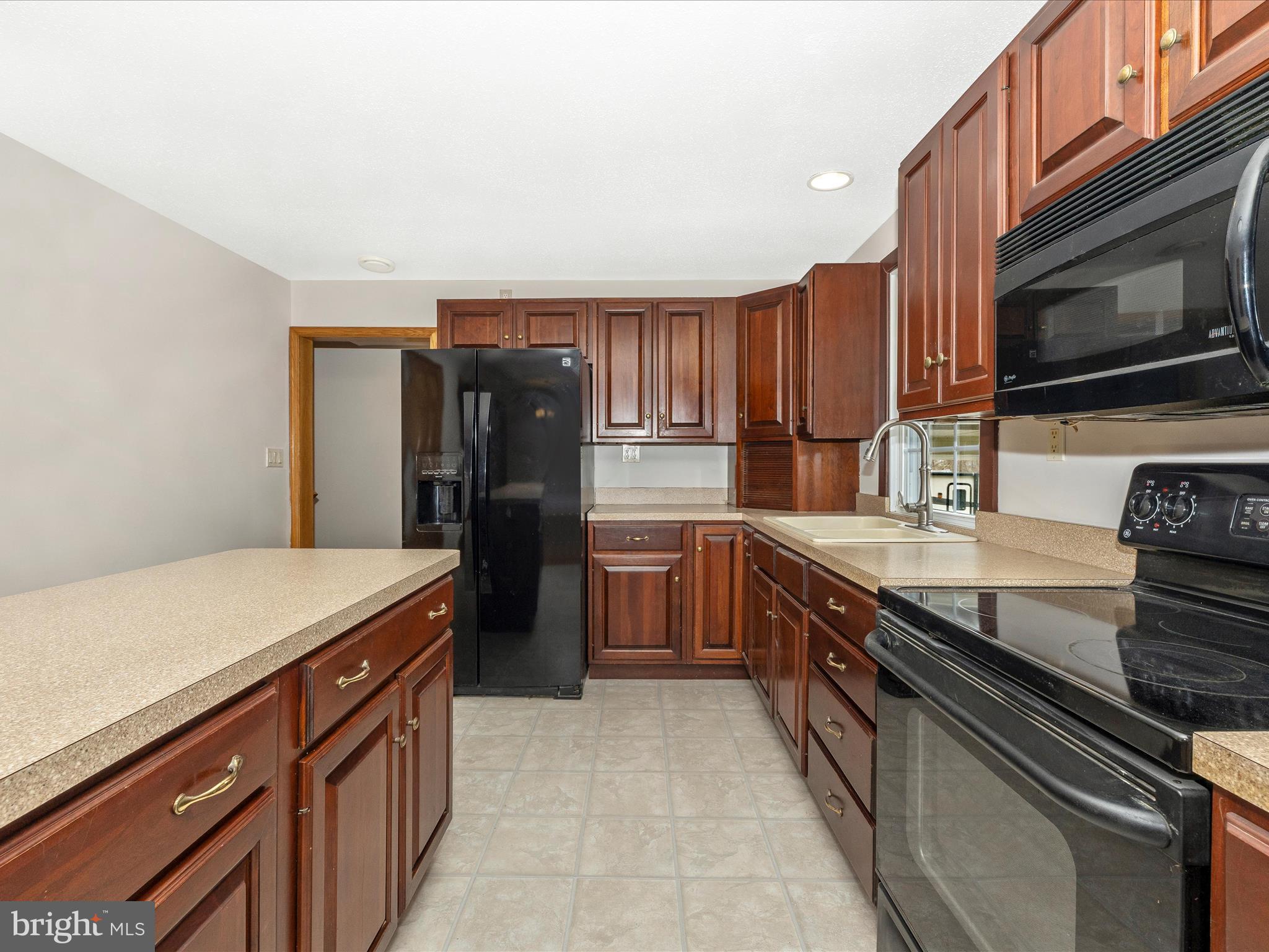 4439 John Draper Road Smithsburg, MD 21783 - Photo 17 of 63 a kitchen with stainless steel appliances granite countertop a stove a sink and a refrigerator