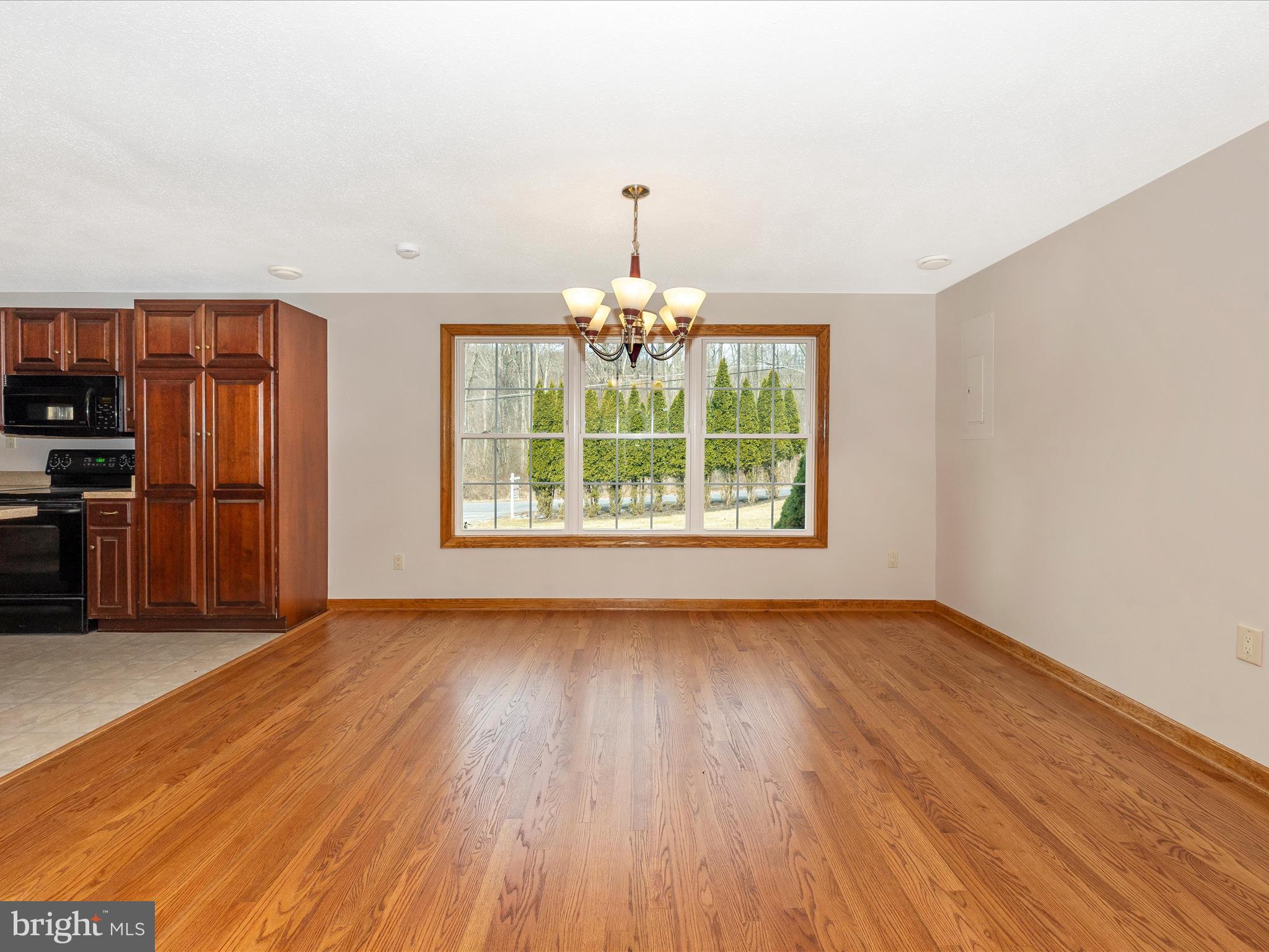 4439 John Draper Road Smithsburg, MD 21783 - Photo 22 of 63 an empty room with wooden floor chandelier and entryway