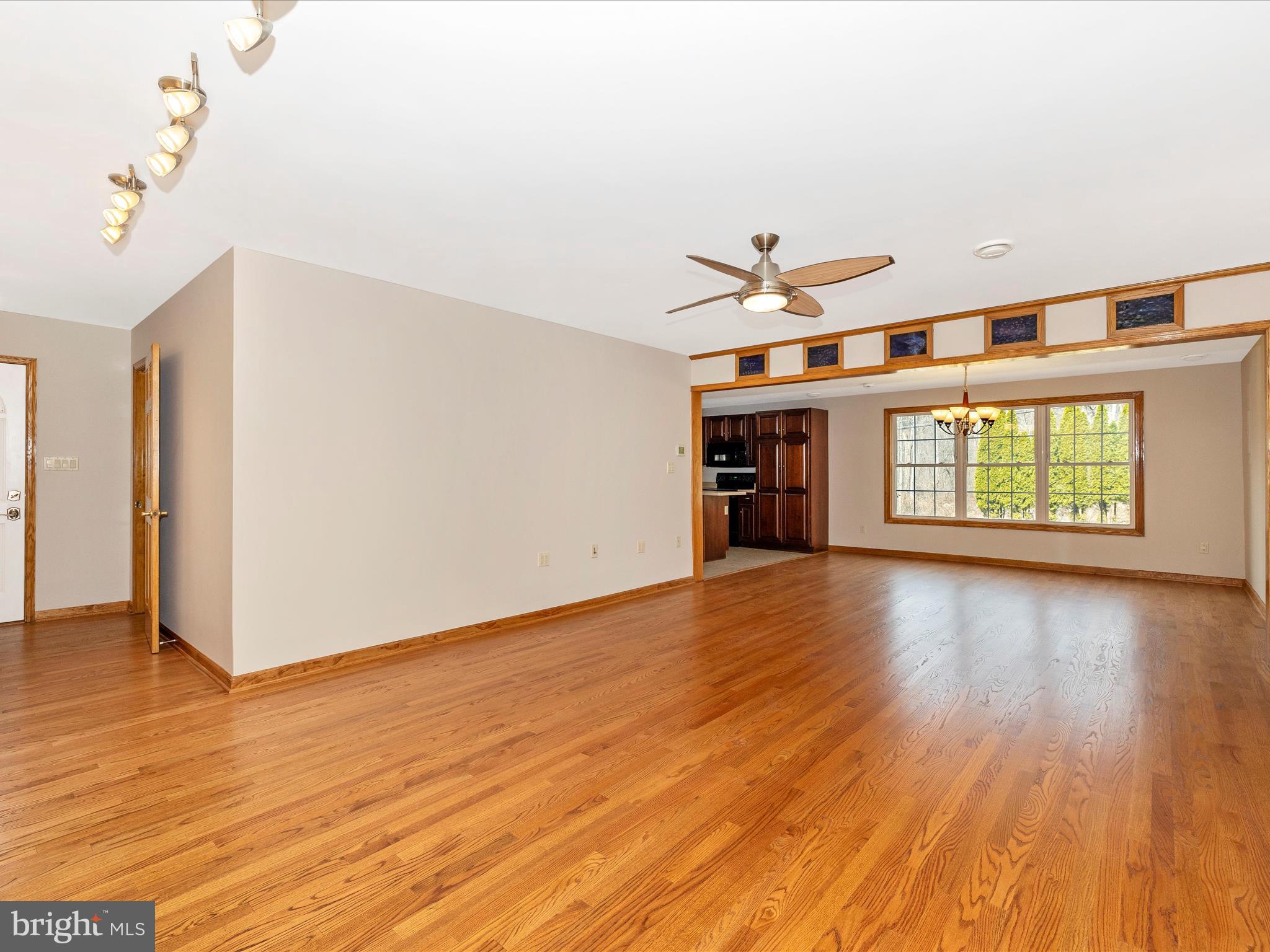 4439 John Draper Road Smithsburg, MD 21783 - Photo 26 of 63 an empty room with wooden floor chandelier and windows