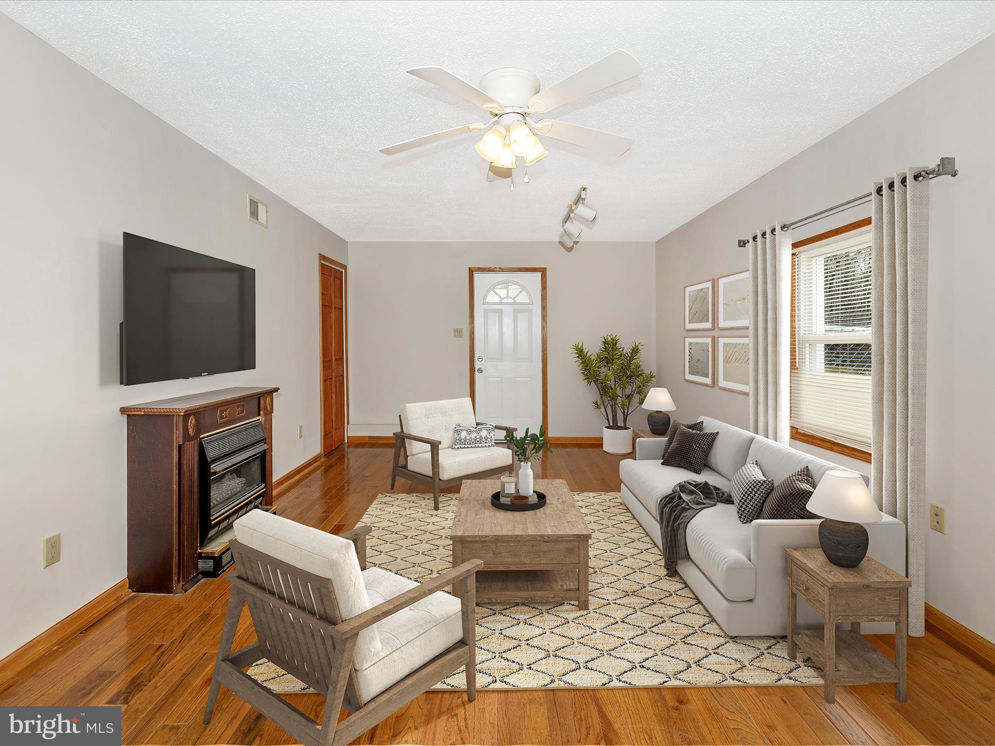 4439 John Draper Road Smithsburg, MD 21783 - Photo 8 of 63 a living room with fireplace furniture and a flat screen tv