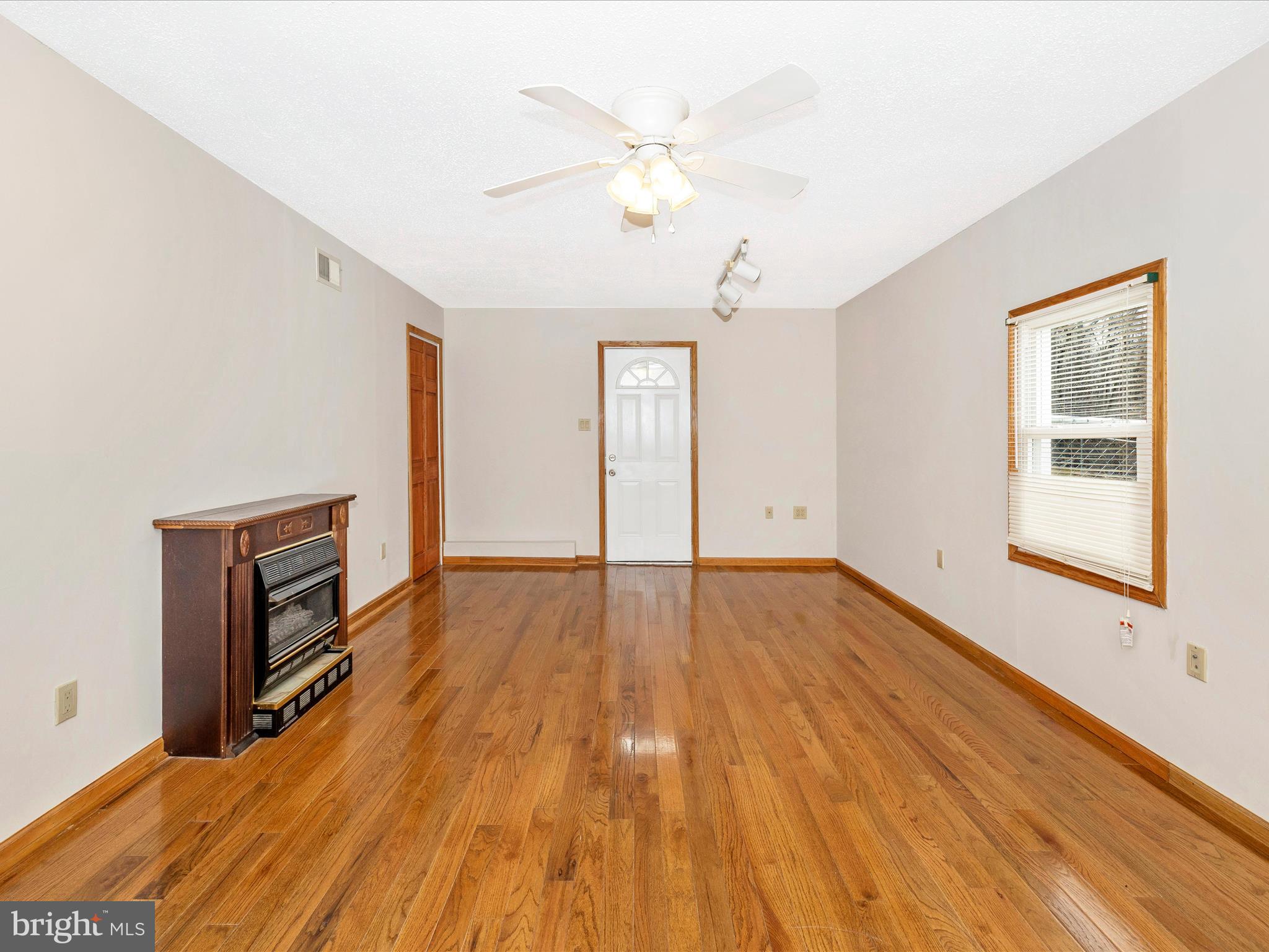 4439 John Draper Road Smithsburg, MD 21783 - Photo 9 of 63 a view of an empty room with wooden floor and a window