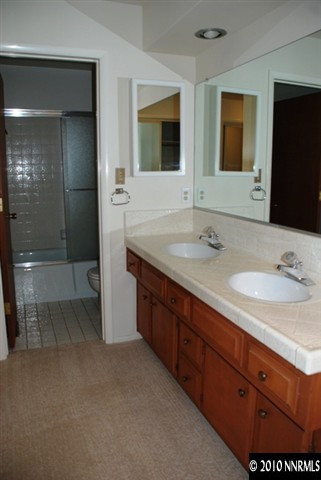 4803 Lakeridge Terrace West Reno, NV 89509 - Photo 4 of 6 a bathroom with double vanity and a mirror