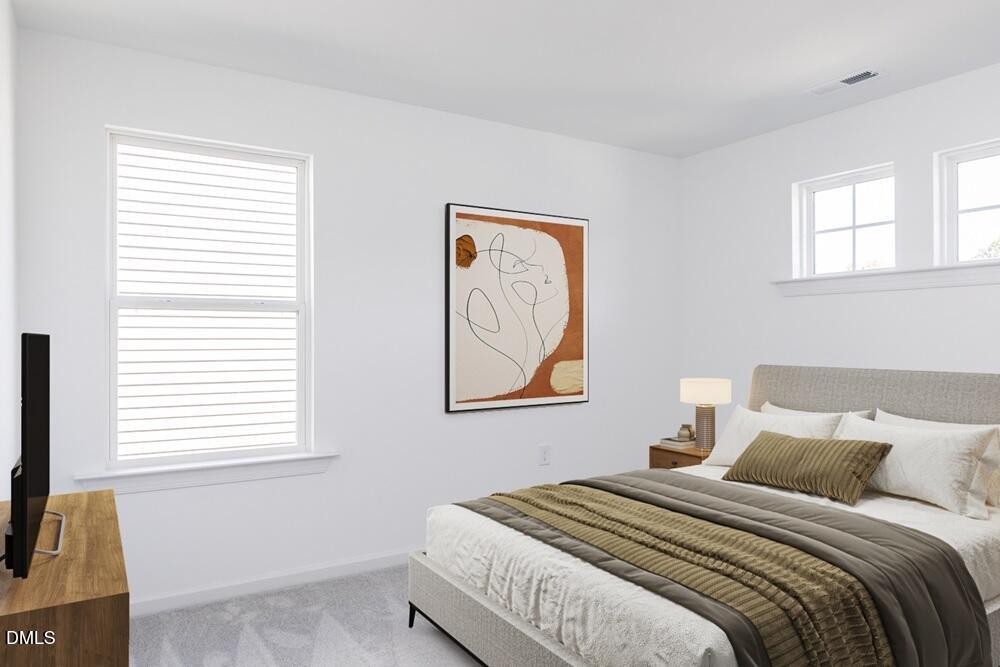 247 Blue Butterfly Drive Angier, NC 27501 - Photo 11 of 41 a bedroom with a bed and a window