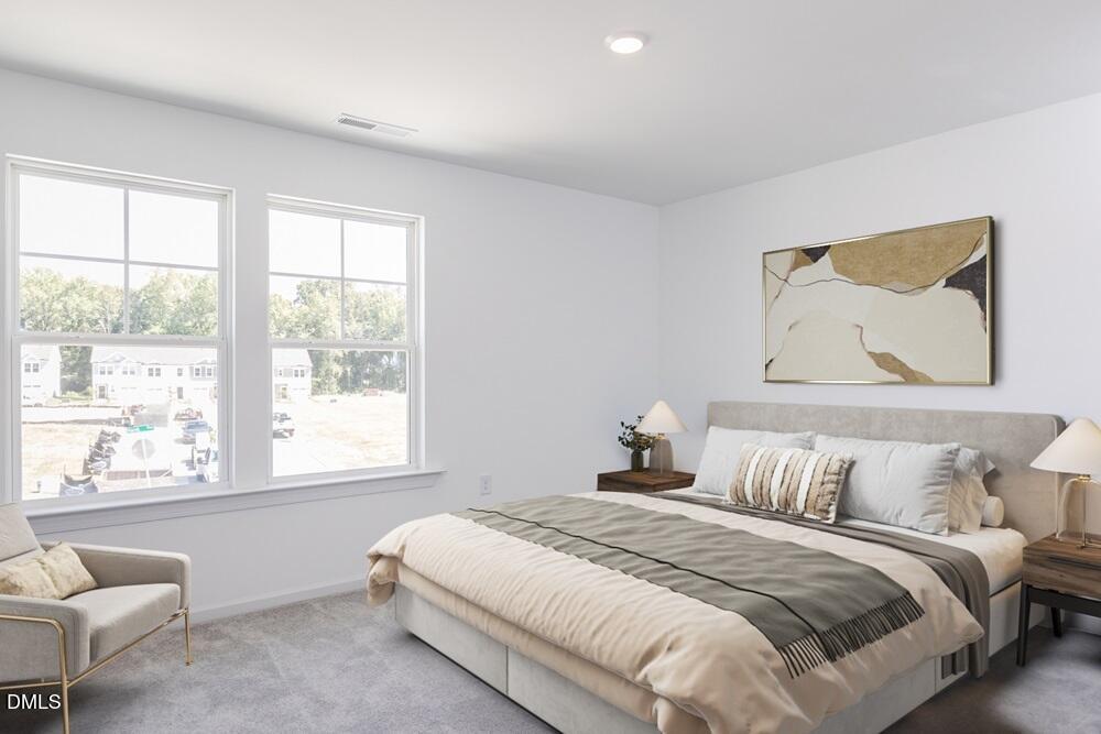 247 Blue Butterfly Drive Angier, NC 27501 - Photo 12 of 41 a bedroom with a bed and a large window