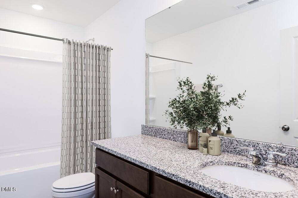 247 Blue Butterfly Drive Angier, NC 27501 - Photo 13 of 41 a bathroom with a granite countertop sink and a mirror