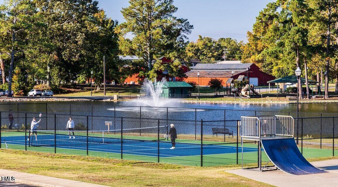247 Blue Butterfly Drive Angier, NC 27501 - Photo 36 of 41 a view of a swimming pool with a bench and trees around
