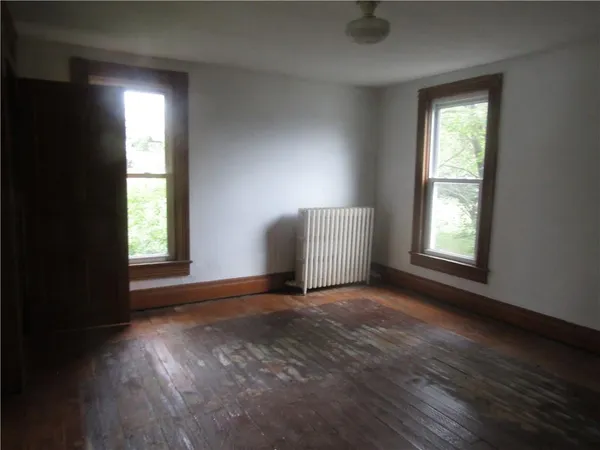an empty room with windows and closet