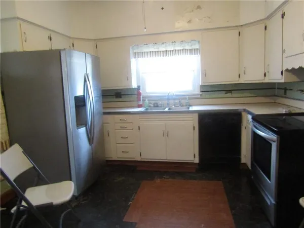 a kitchen with a sink stove and refrigerator